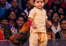 The Baby and His Rooster Who Made the World Smile. The stage lights shimmered across the floor, reflecting on a little pair of bare feet.
